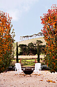 Fire pit and two chairs in autumnal garden
