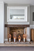 Wall mirror with white frame, candle decoration underneath