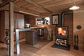 Stainless steel kitchen counter and woodstove in a wooden hut