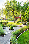 Spring garden with paving stones and gravel path