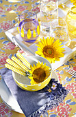 Bowl with cutlery and sunflower blossom