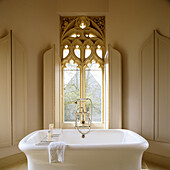 Filigree carved stone window in bathroom, painted taupe
