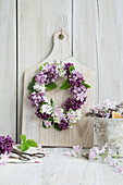 Wreath of lilacs on a wooden board