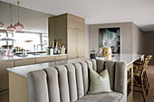 Kitchen island with custom-made sofa in open-plan living room