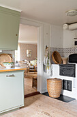 Kitchen with wood stove and kitchenette in mint green