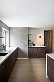 Bright, open kitchen with dark cupboard fronts