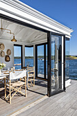 Wooden cottage by the water, view into dining area