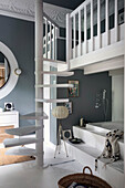 Recessed bathtub with platform, spiral staircase leads to the sleeping area