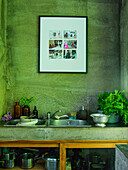 Kitchen utensils and herbs on concrete sink table