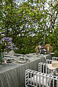 Set table under lilac bush in garden