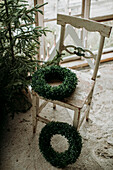 Christmas tree and wreaths on old chair