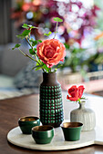 Flowers in vases and green cups