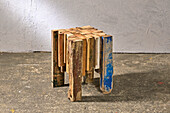 DIY stool made from recycled wood on concrete floor