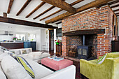 Cozy seating area in front of rustic fireplace with red bricks