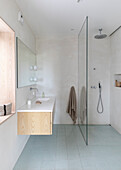 Bright bathroom, shower area with a glass partition shower wall