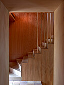 View of concrete staircase with wooden paneling