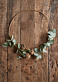 Decorative wreath with eucalyptus branches and golden cones