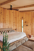 King size bed in wood paneled room