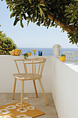 Bright armchair on terrace with sea view