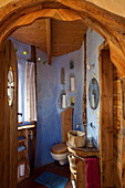 Bathroom with blue walls and wooden elements