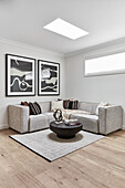 Modern living room in neutral tones with black, carved wood coffee table