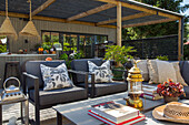 Terrace lounge with upholstered furniture and decorative accessories