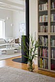 Bright living room with wood-burning stove and bookcase