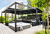 Modern garden pavilion with whirlpool and outdoor kitchen