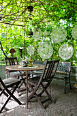 Green seating area with delicate lace tablecloths as decoration