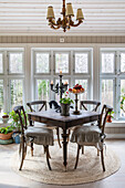Set wooden table and chairs in the dining room with a view of the countryside