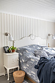 Bedroom with white bed and white bedside tables