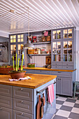Country kitchen in grey tones with floral decoration