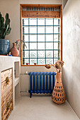 Bathroom with blue radiator and glass brick window