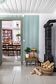 Antique tiled stove next to vintage-style doorway to the dining room