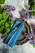 Vintage spring place setting with purple lilacs
