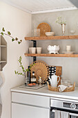 Kitchen corner with wooden shelves and natural decorative elements