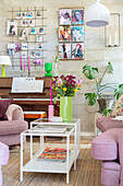 Living room with colourful accents, bouquet of flowers and piano