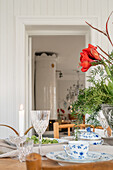 Set table with blue and white crockery and red amaryllis