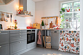 Country-style kitchen with grey cabinets and Christmas decorations