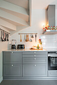 Modern kitchen in grey with illuminated worktop and Christmas decorations