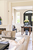 Entrance area with round table and floral decorations, light color scheme