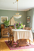 Dining area with crystal chandelier and antique wooden furniture