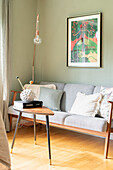 Grey retro sofa, decorative pillows and picture