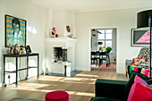 Living room with fireplace, artwork and colorful accents