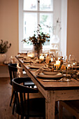 Dining table setting with candles and wine glasses