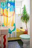 Small bathroom with colorful printed shower curtain