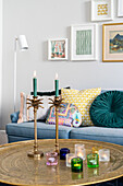 Living room with golden table, candles and murals