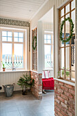 Brick walls and Christmas decorations with candles, fir branches and wreaths