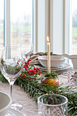 Festive dining table with candles and fir branches