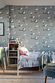 Bed and shelf in the children's room, wallpaper with flamingo motif